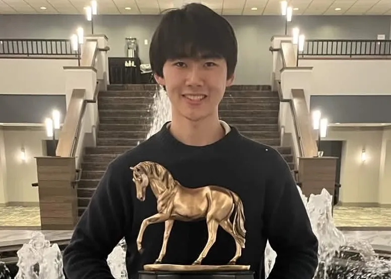 Bolang Zhu holding his TOC champion trophy
